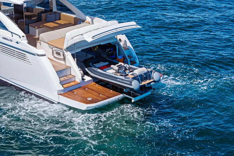 Blue Daksa Yacht Photos Pics Luxury Absolute 64 yacht with tender boat on blue ocean waters, 2013 model.