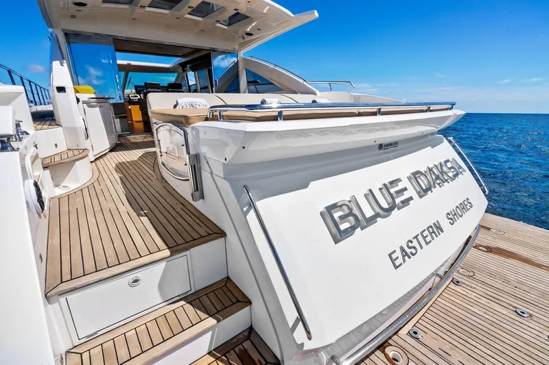 Blue Daksa Yacht Photos Pics Luxurious 2013 Absolute 64 yacht "Blue Drake" on open sea, featuring elegant wooden deck.