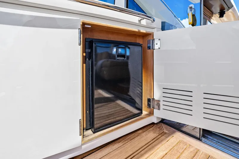 Blue Daksa Yacht Photos Pics Open cabinet on Absolute 64 yacht, revealing a compact refrigerator, 2013 model.