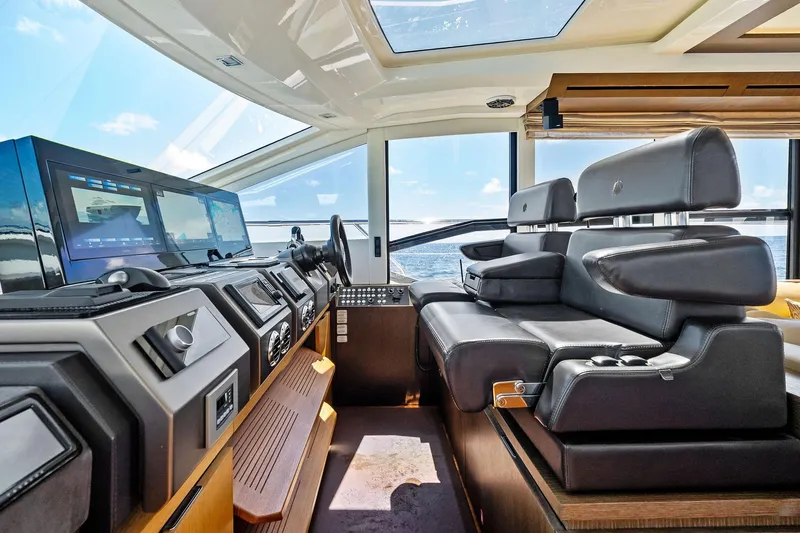 Blue Daksa Yacht Photos Pics Luxurious interior of a 2013 Absolute 64 yacht with modern navigation equipment and leather seating.