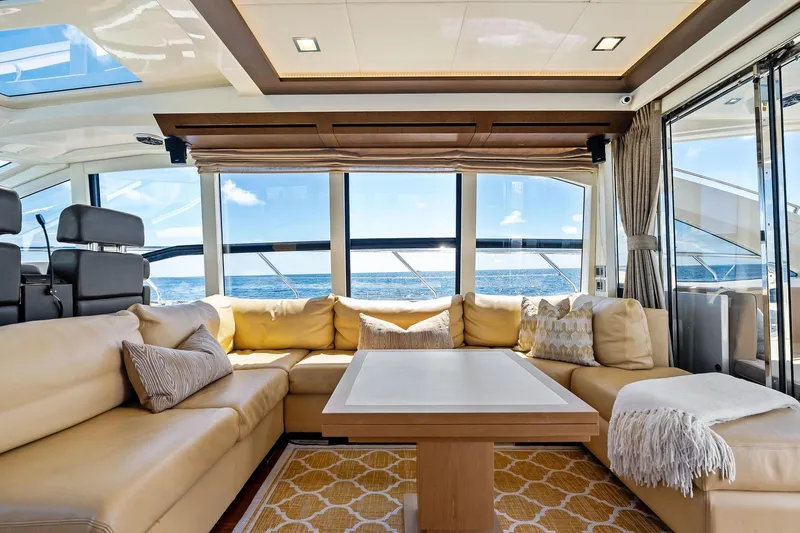 Blue Daksa Yacht Photos Pics Luxurious interior of 2013 Absolute 64 yacht with ocean view, beige seating, and modern decor.