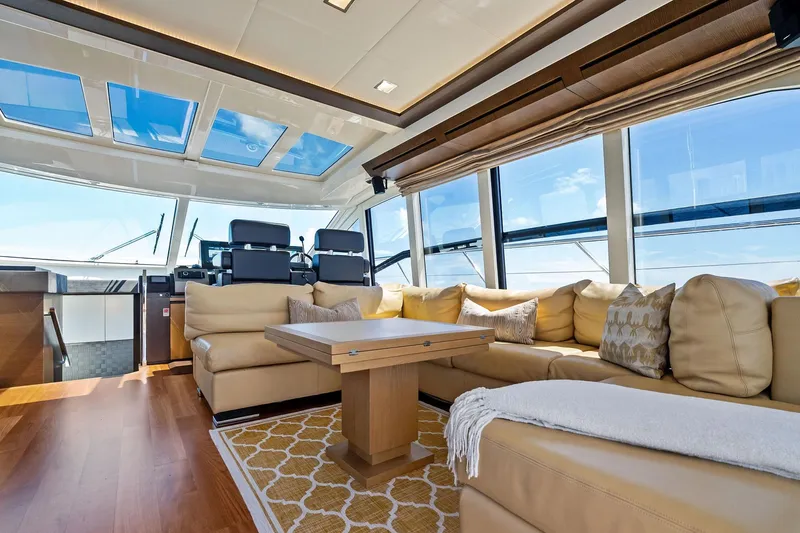 Blue Daksa Yacht Photos Pics Luxurious interior of 2013 Absolute 64 yacht with plush seating and panoramic windows.