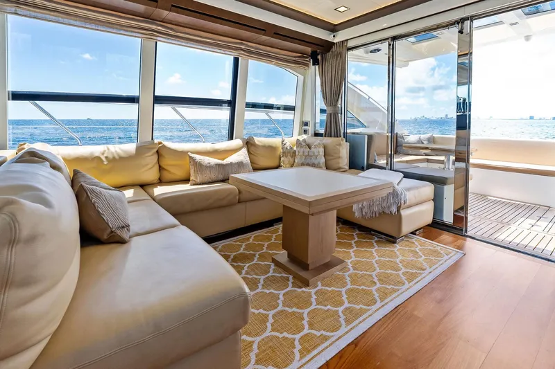 Blue Daksa Yacht Photos Pics Luxurious interior of 2013 Absolute 64 yacht with ocean view, featuring plush seating and elegant decor.