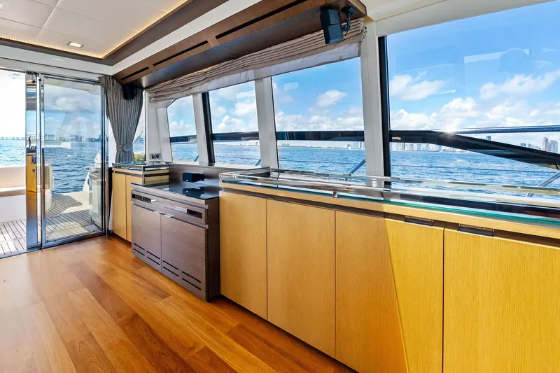 Blue Daksa Yacht Photos Pics Luxurious interior of a 2013 Absolute 64 yacht with ocean view through large windows.