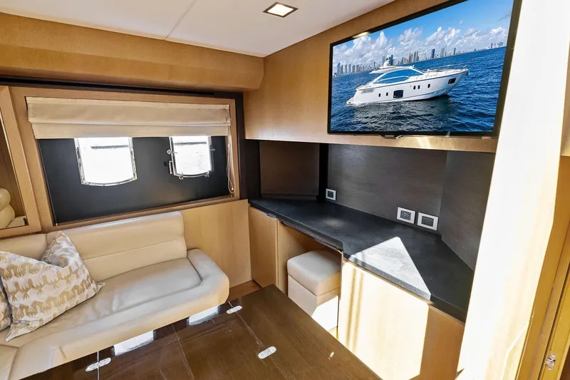 Blue Daksa Yacht Photos Pics Luxurious interior of 2013 Absolute 64 yacht with sofa, desk, and TV.
