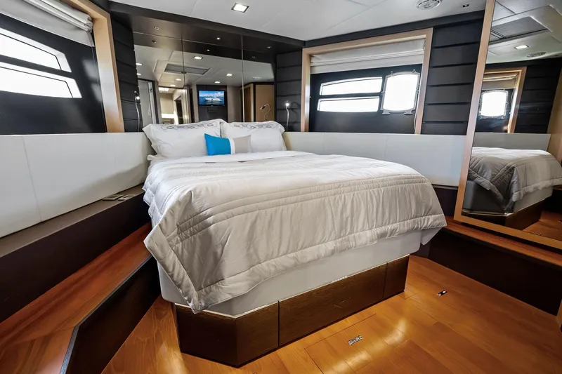 Blue Daksa Yacht Photos Pics Luxurious bedroom interior on a 2013 Absolute 64 yacht, featuring elegant bedding and modern design.