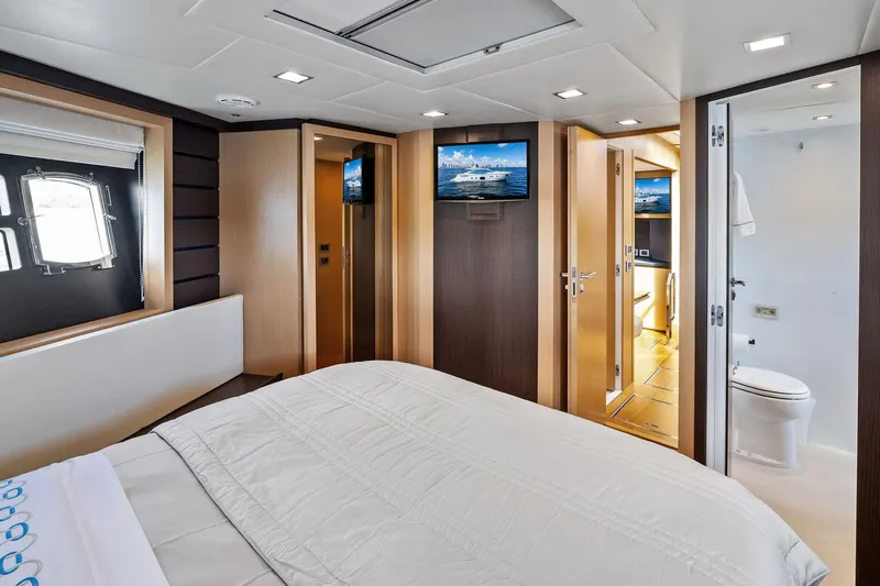 Blue Daksa Yacht Photos Pics Luxurious bedroom interior on 2013 Absolute 64 yacht, featuring modern design and en-suite bathroom.