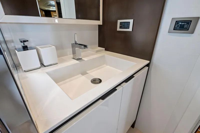 Blue Daksa Yacht Photos Pics Modern bathroom sink on Absolute 64 yacht, 2013 model, with sleek fixtures and controls.