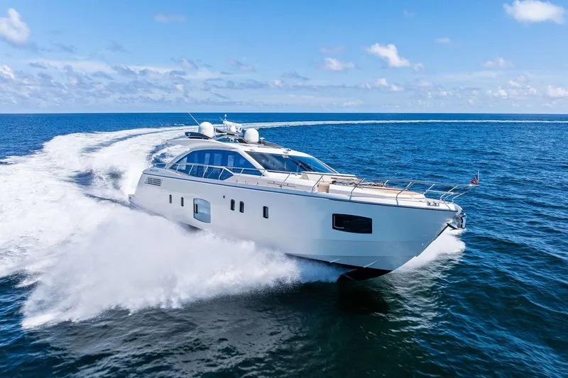 Blue Daksa Yacht Photos Pics Luxurious 2013 Absolute 64 yacht cruising on open sea under clear blue sky.