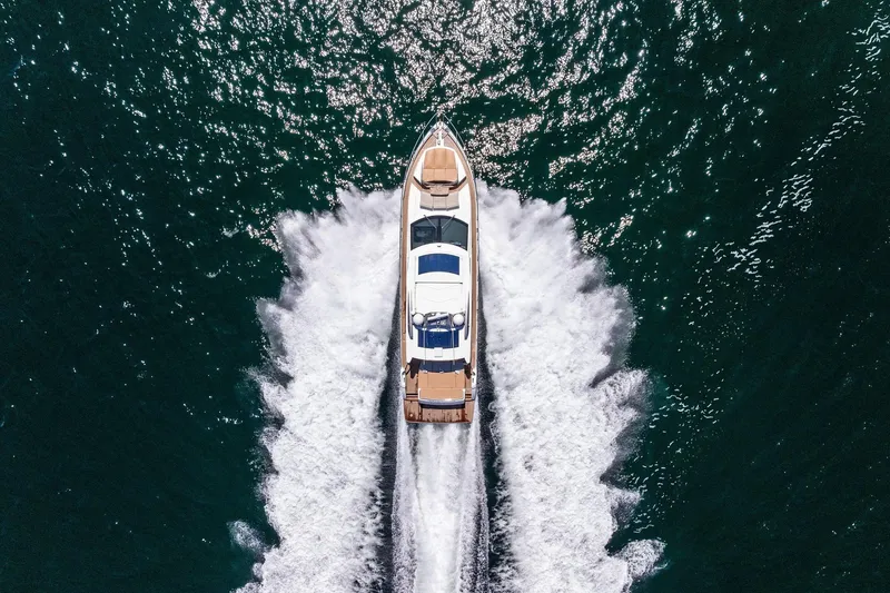 Blue Daksa Yacht Photos Pics Aerial view of 2013 Absolute 64 yacht cruising on open water.