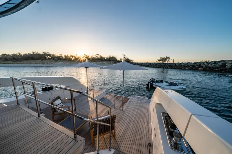 Violetta Yacht Photos Pics Sanlorenzo SX76 yacht deck at sunset, 2021 model, with scenic waterfront view.