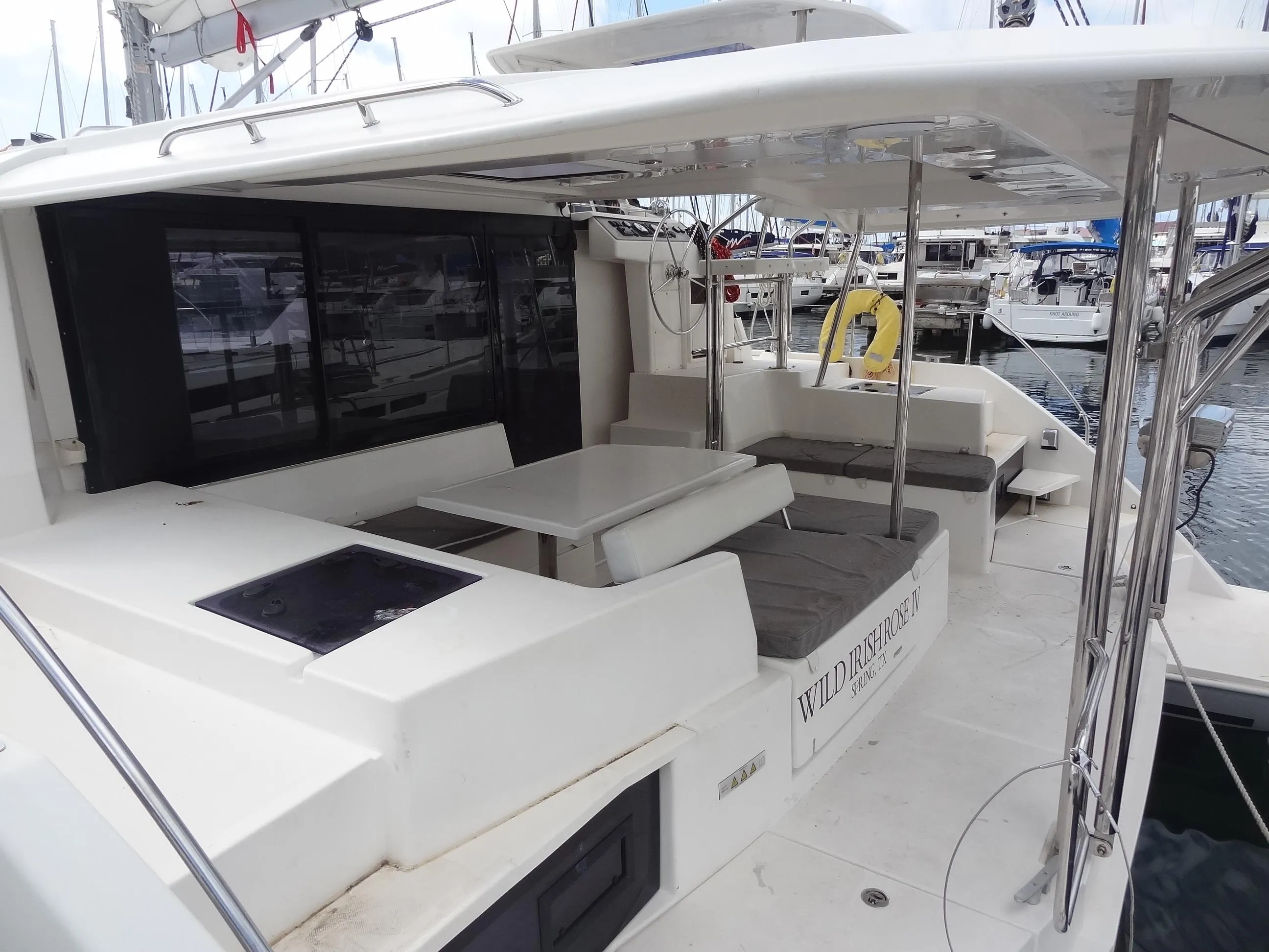 2020 Leopard 40 catamaran with spacious outdoor seating and dining area in marina.