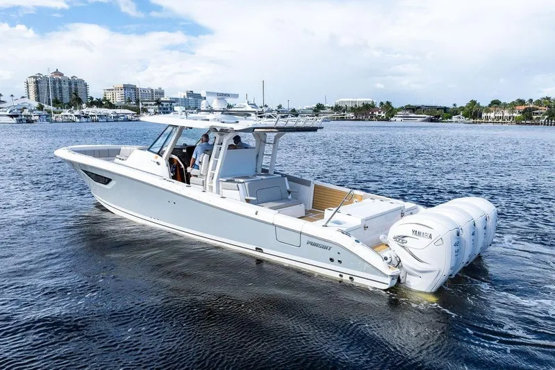 No Vacancy Yacht Photos Pics 2022 Pursuit S 428 Sport boat cruising on a scenic waterfront.
