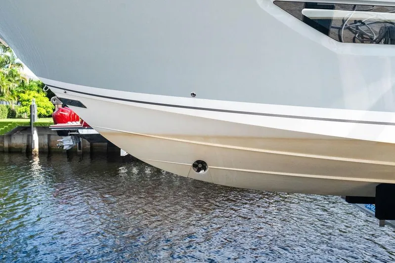 No Vacancy Yacht Photos Pics 2022 Pursuit S 428 Sport boat hull above water, dockside view.