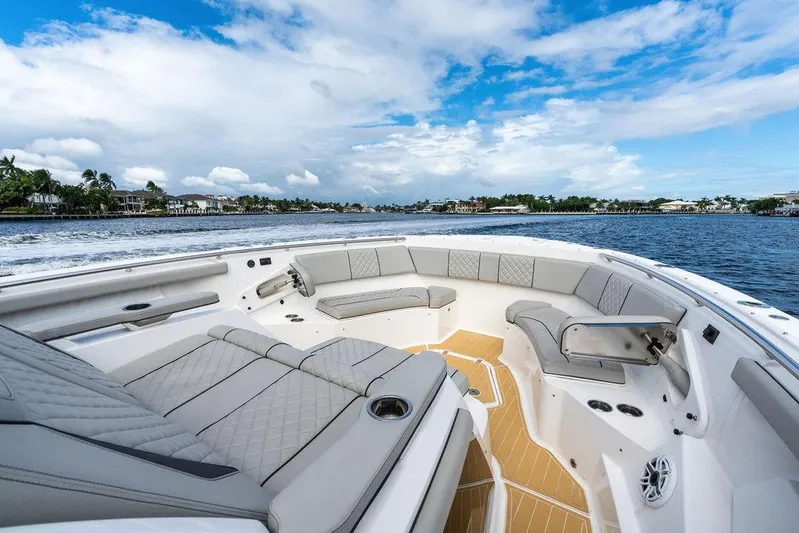 No Vacancy Yacht Photos Pics 2022 Pursuit S 428 Sport boat interior with luxurious seating on open water.