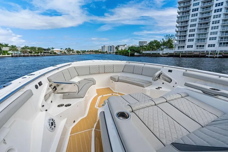 No Vacancy Yacht Photos Pics Luxurious 2022 Pursuit S 428 Sport boat interior with plush seating and waterfront view.