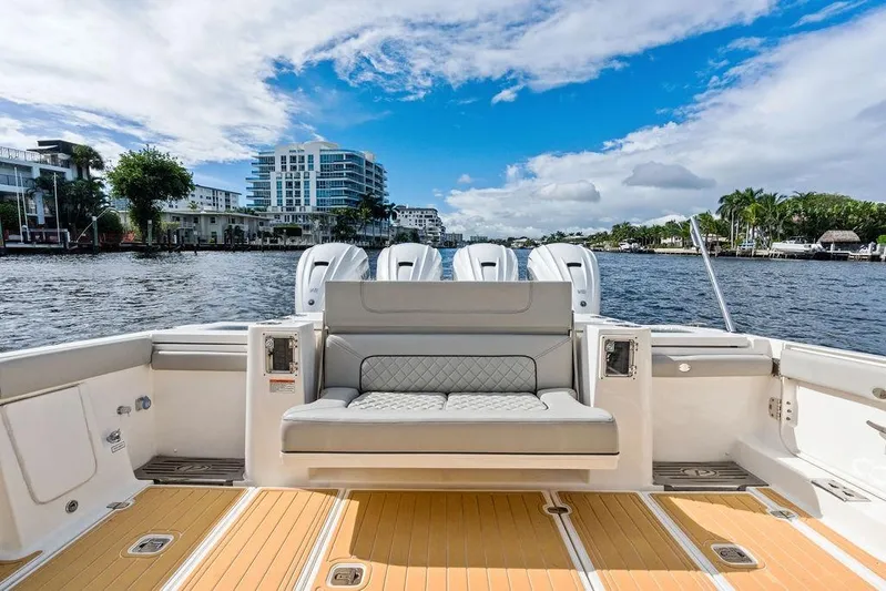 No Vacancy Yacht Photos Pics 2022 Pursuit S 428 Sport boat interior with waterfront view, featuring luxurious seating and modern design.