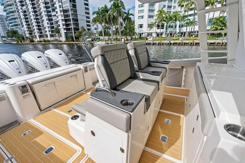 No Vacancy Yacht Photos Pics 2022 Pursuit S 428 Sport boat interior with luxury seating and waterfront view.