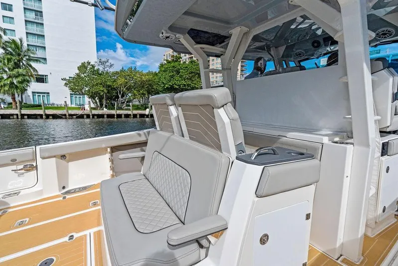No Vacancy Yacht Photos Pics 2022 Pursuit S 428 Sport boat interior with luxurious seating and modern design.