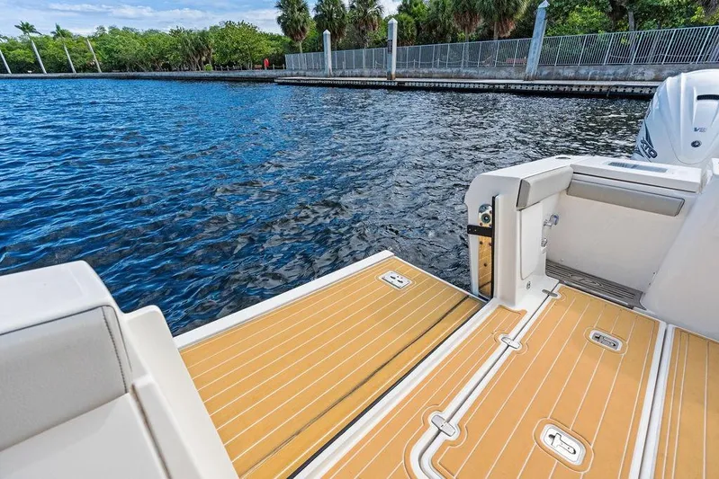 No Vacancy Yacht Photos Pics 2022 Pursuit S 428 Sport boat deck with water view and lush greenery.