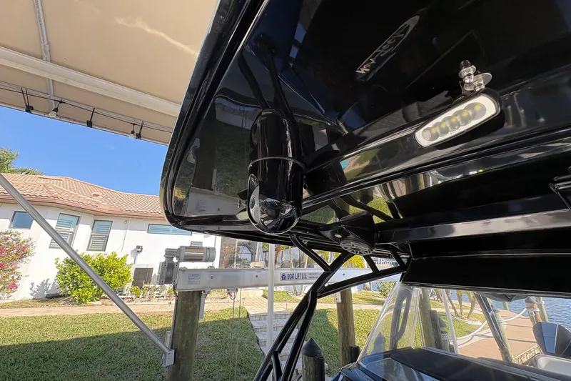  Yacht Photos Pics 2023 Nor-Tech 390 Sport Center Console boat under canopy, showcasing sleek design and lighting.