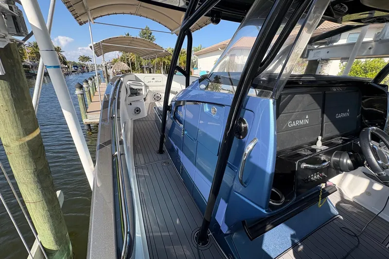  Yacht Photos Pics 2023 Nor-Tech 390 Sport Center Console boat docked, featuring Garmin navigation systems.