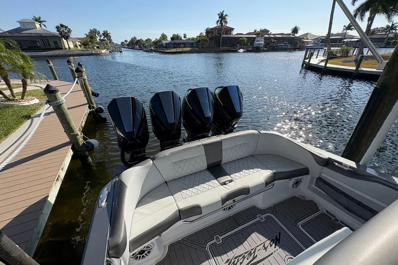  Yacht Photos Pics 2023 Nor-Tech 390 Sport Center Console boat docked by a scenic waterfront.