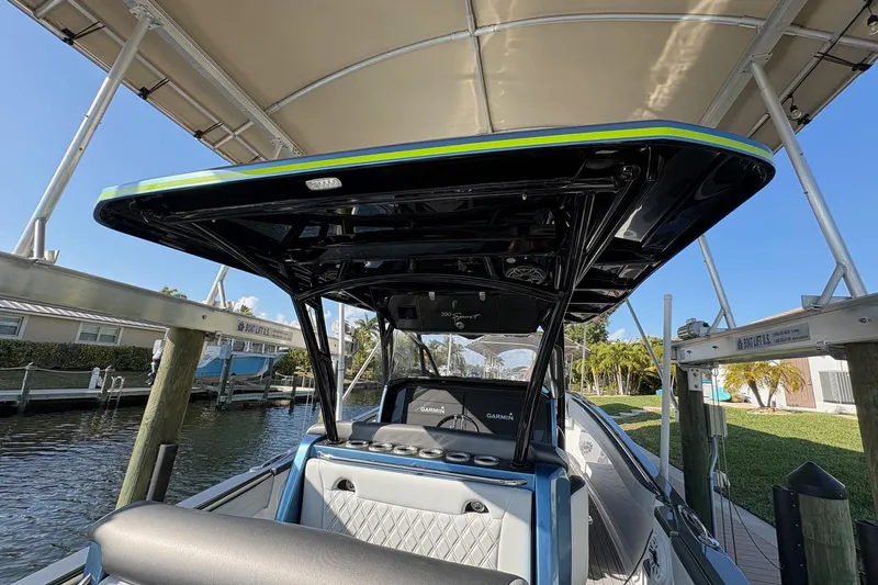  Yacht Photos Pics 2023 Nor-Tech 390 Sport Center Console boat docked under canopy.