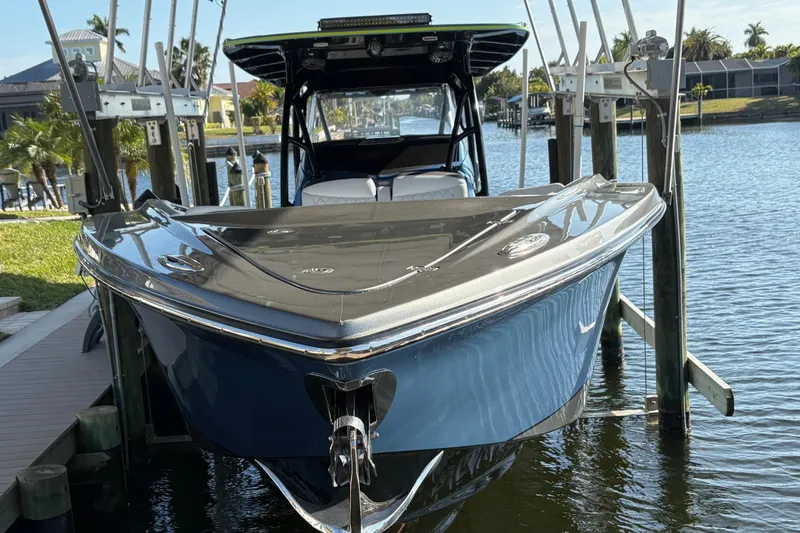  Yacht Photos Pics 2023 Nor-Tech 390 Sport Center Console boat docked by waterfront homes.