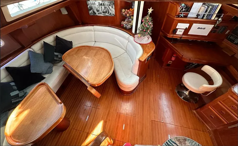 Sarama Yacht Photos Pics Luxurious 1988 Ancosta Dubois yacht interior with wooden flooring and elegant seating area.