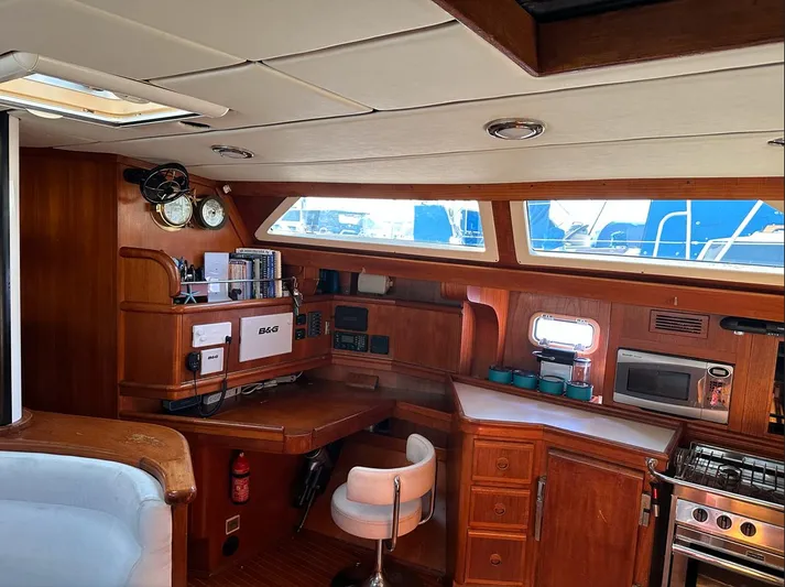 Sarama Yacht Photos Pics Interior of 1988 Custom Ancosta Dubois yacht with wooden cabinetry and navigation equipment.