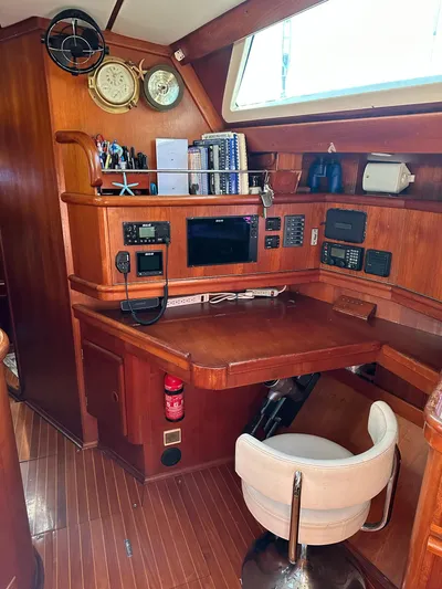 Sarama Yacht Photos Pics 1988 Custom Ancosta Dubois yacht interior with navigation station and wooden furnishings.