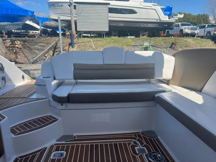  Yacht Photos Pics 2015 Four Winns H350 boat interior with cushioned seating and wood flooring.
