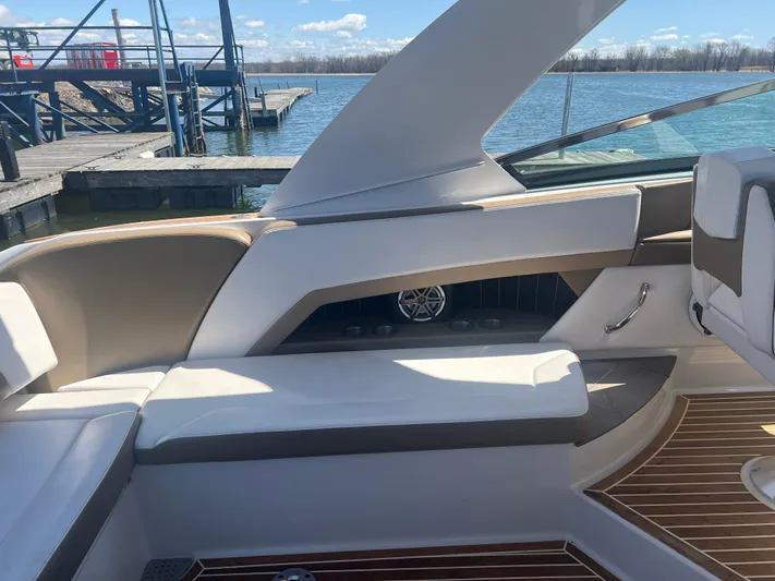  Yacht Photos Pics 2015 Four Winns H350 boat interior with white seating and wood accents by the dock.