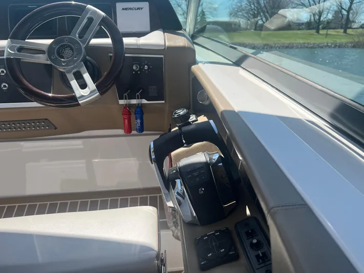  Yacht Photos Pics 2015 Four Winns H350 boat cockpit with steering wheel and controls, featuring a Mercury system.