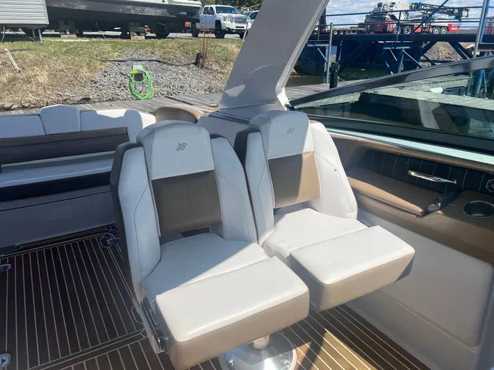  Yacht Photos Pics 2015 Four Winns H350 boat interior with dual seats and wooden flooring.
