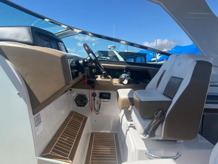  Yacht Photos Pics Interior of 2015 Four Winns H350 boat with steering wheel and seating.