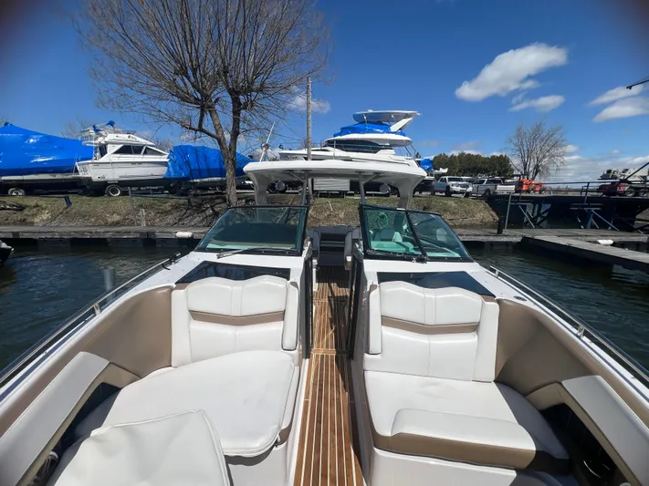  Yacht Photos Pics 2015 Four Winns H350 boat with white seating, docked under a clear blue sky.