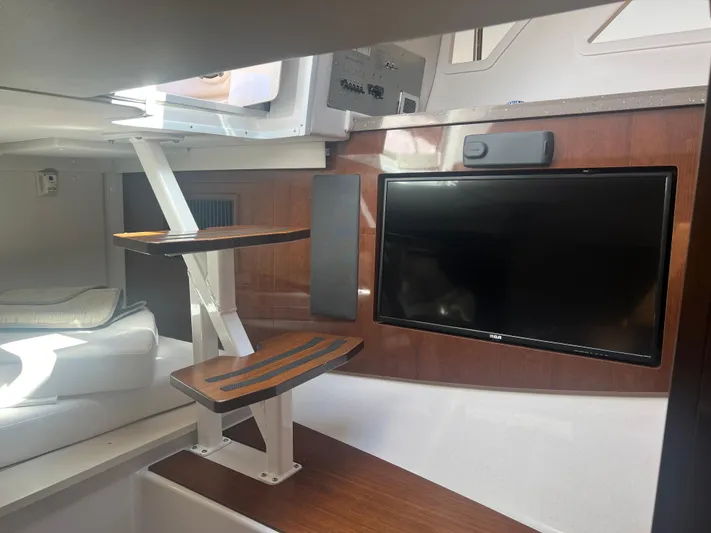  Yacht Photos Pics Interior of 2015 Four Winns H350 boat with TV and wooden steps.