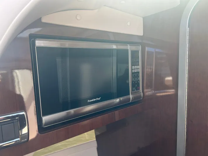  Yacht Photos Pics Built-in microwave in 2015 Four Winns H350 boat interior.