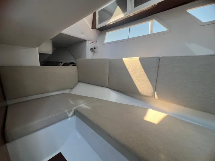  Yacht Photos Pics Interior seating area of a 2015 Four Winns H350 boat, featuring beige cushions.