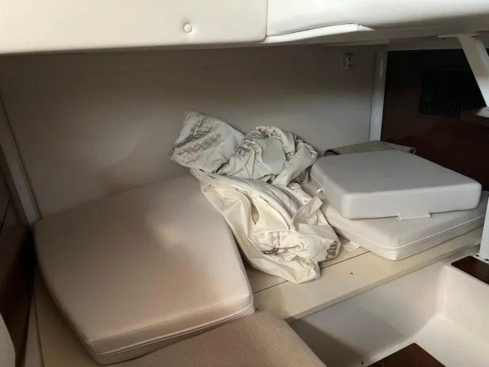  Yacht Photos Pics Interior storage area of a 2015 Four Winns H350 boat with cushions and fabric.