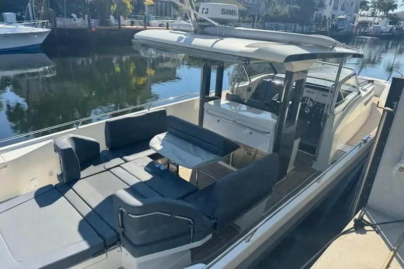 Nim2021xyz21 Yacht Photos Pics 2021 Nimbus T11 boat with spacious seating and modern design docked by the water.