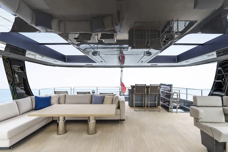 Naoma Yacht Photos Pics Luxurious interior of 2022 Sunreef 70 NAOMA yacht with elegant seating and ocean view.