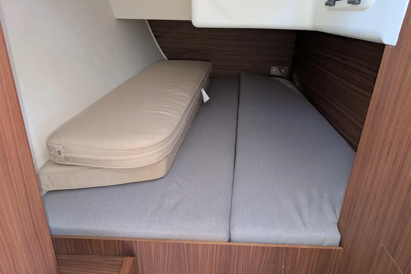 Blue Yonder Yacht Photos Pics 2024 J Boats J/112E cabin interior with cushioned seating and wooden paneling.