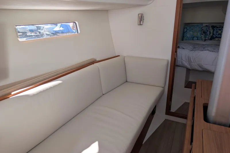 Blue Yonder Yacht Photos Pics 2024 J Boats J/112E interior with white sofa and cozy cabin view.