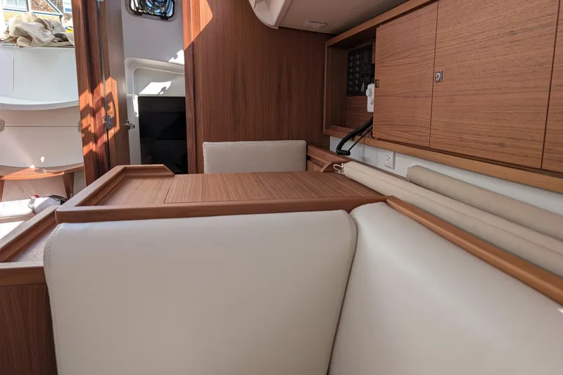Blue Yonder Yacht Photos Pics 2024 J Boats J/112E interior with wood finish and white seating.