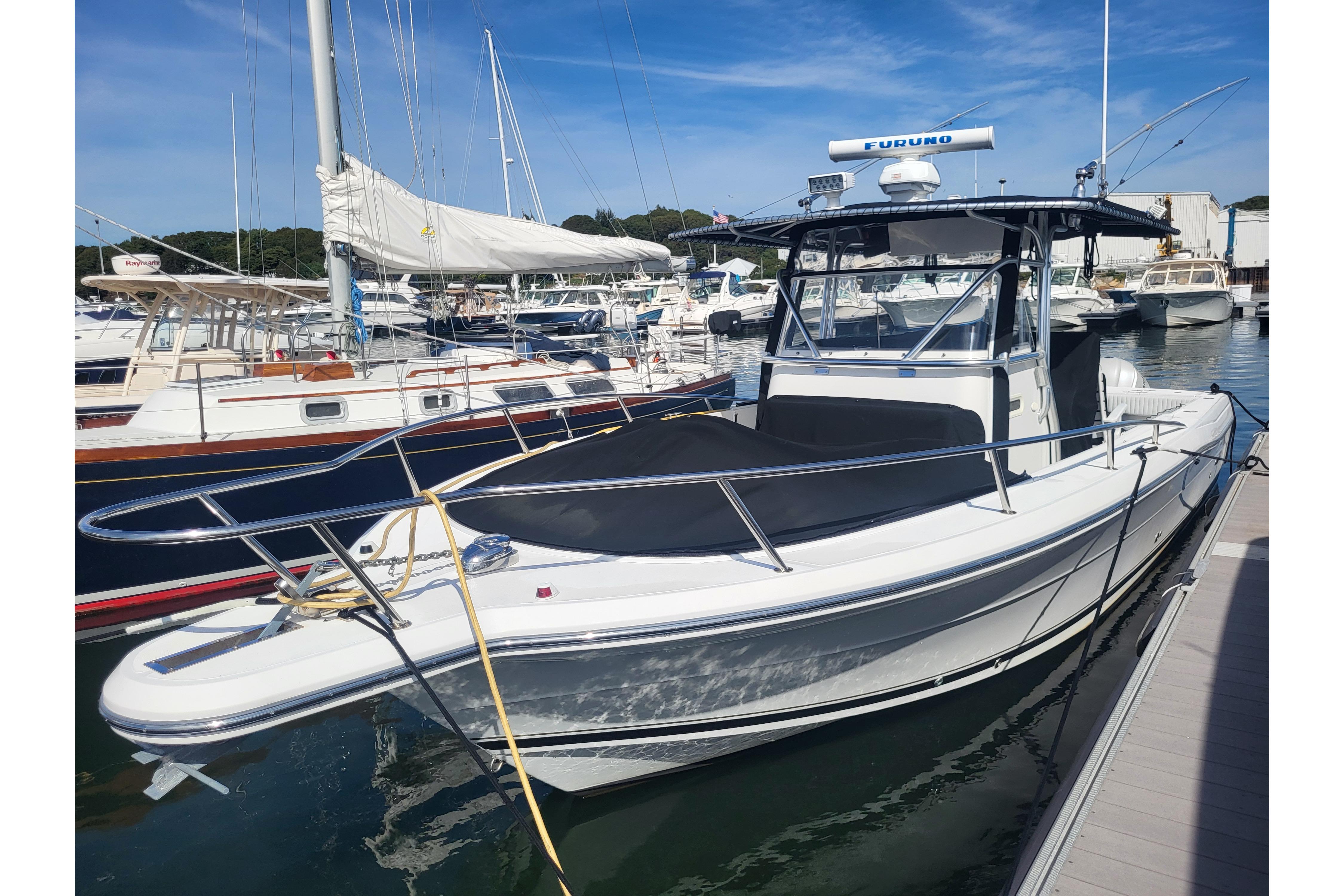 2005 Stamas 310 Tarpon boat docked in a marina, featuring sleek design and modern equipment.