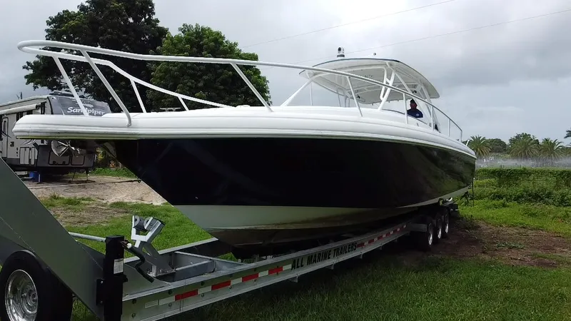  Yacht Photos Pics 2008 Intrepid 390 Sport Yacht on trailer, parked on grass, with trees in background.