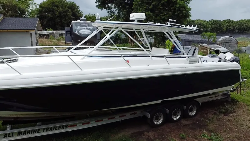  Yacht Photos Pics 2008 Intrepid 390 Sport Yacht on trailer, surrounded by greenery and buildings.
